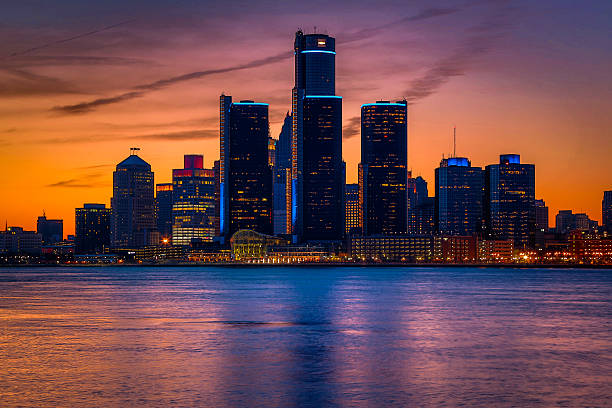 The Detroit skyline and Renaissance Center glowing blue at sunset